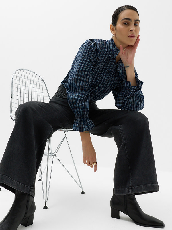 Woman wearing dark jeans and top