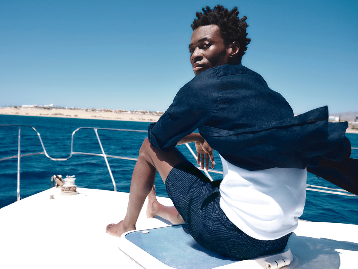Man wearing navy linen shirt and shorts