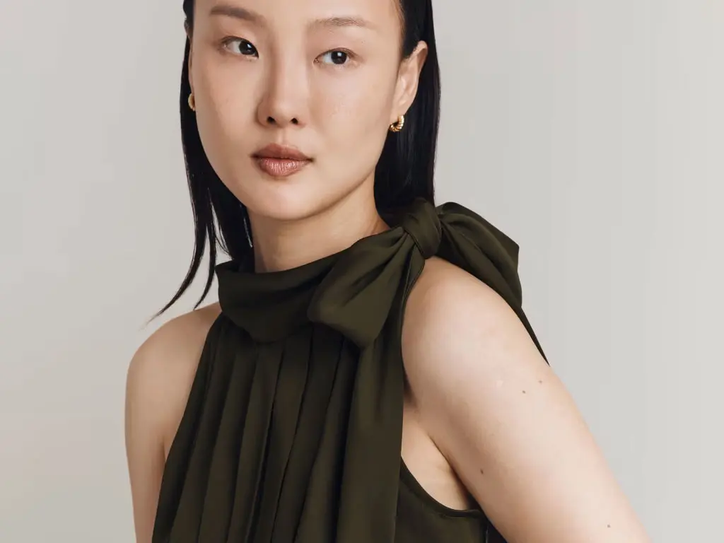 Woman wearing a green crepe jumpsuit at M&S