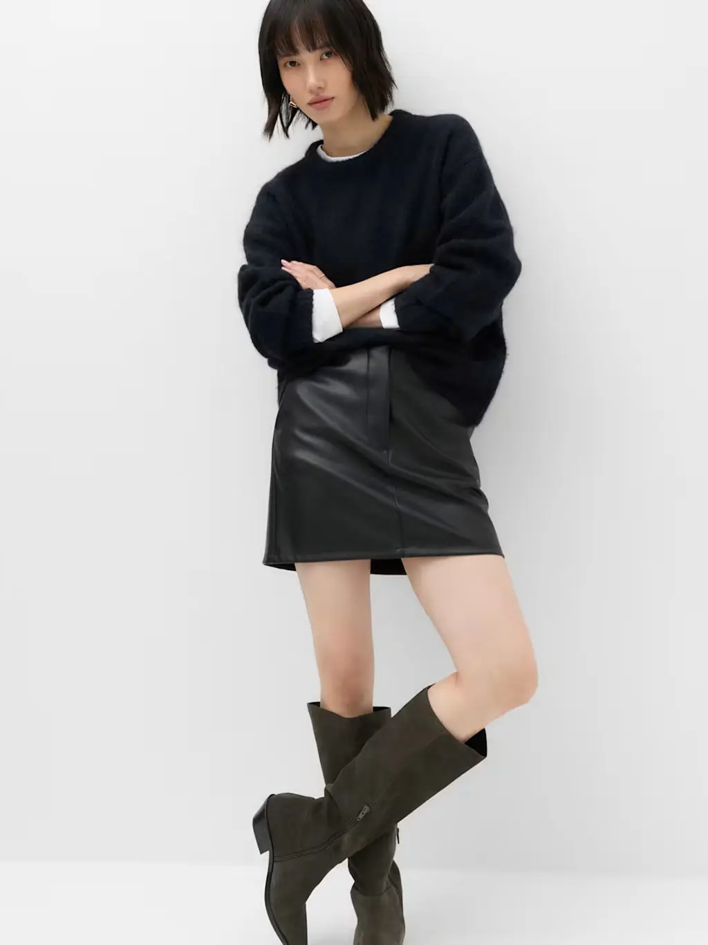 Woman in black mini skirt and black jumper