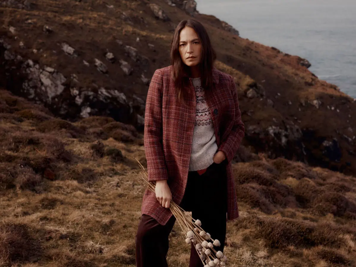 Woman wearing coat over knitwear
