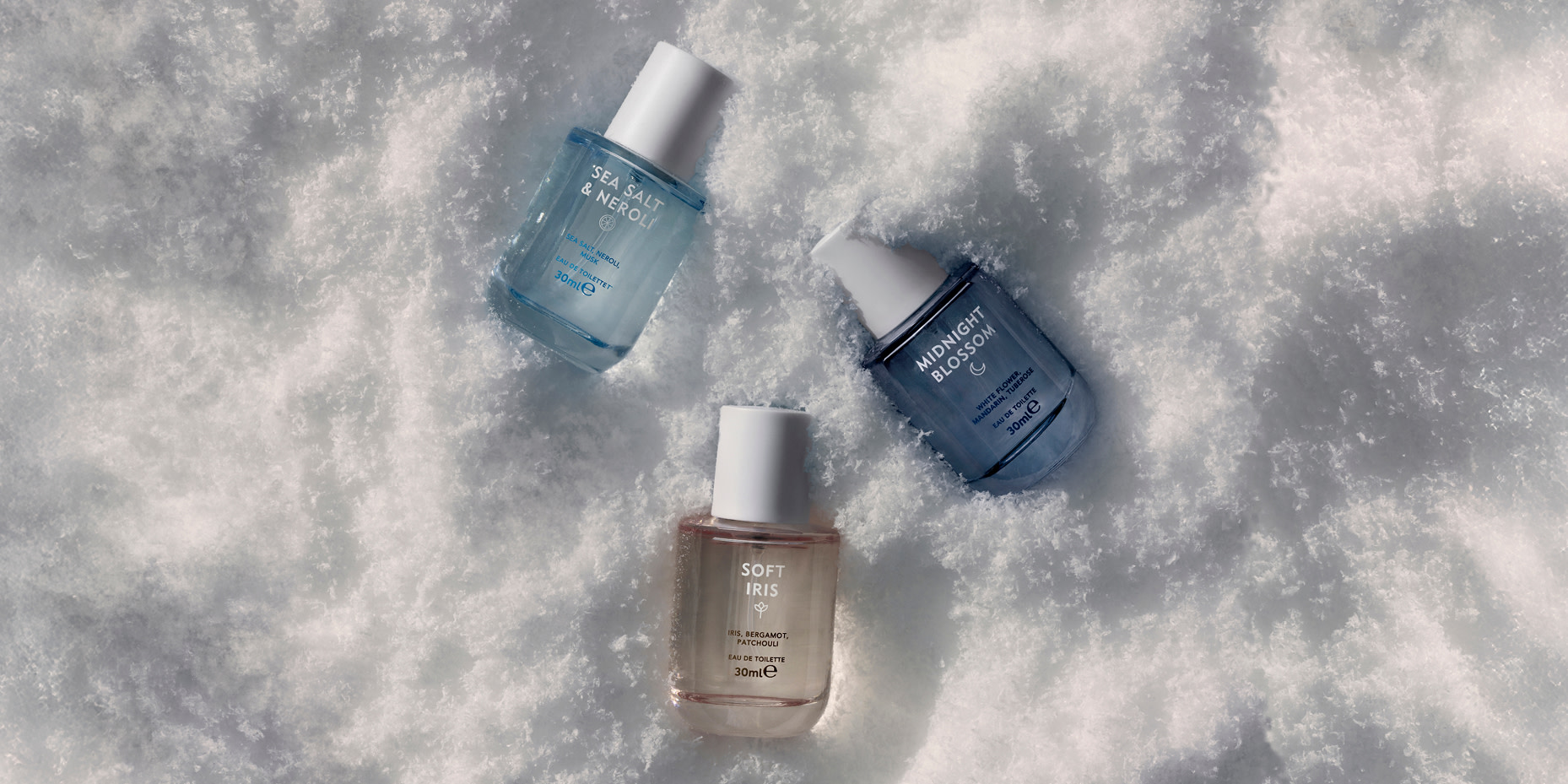 Assorted perfume bottles in the snow