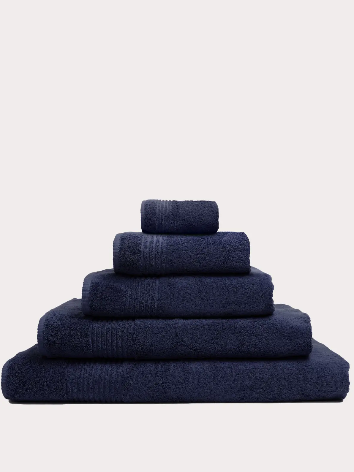 Pile of navy towels of varying sizes 