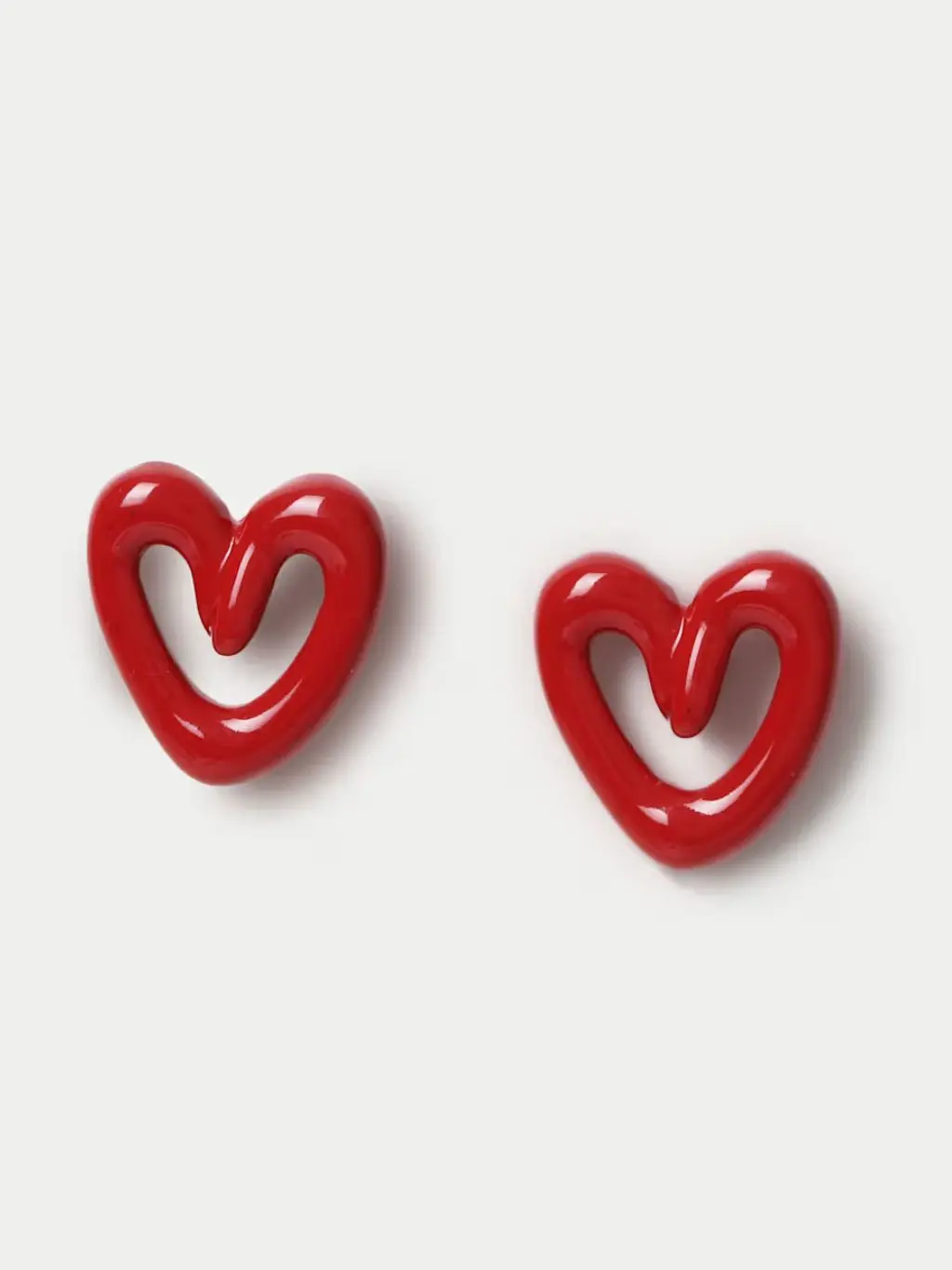A pair of red heart stud earrings