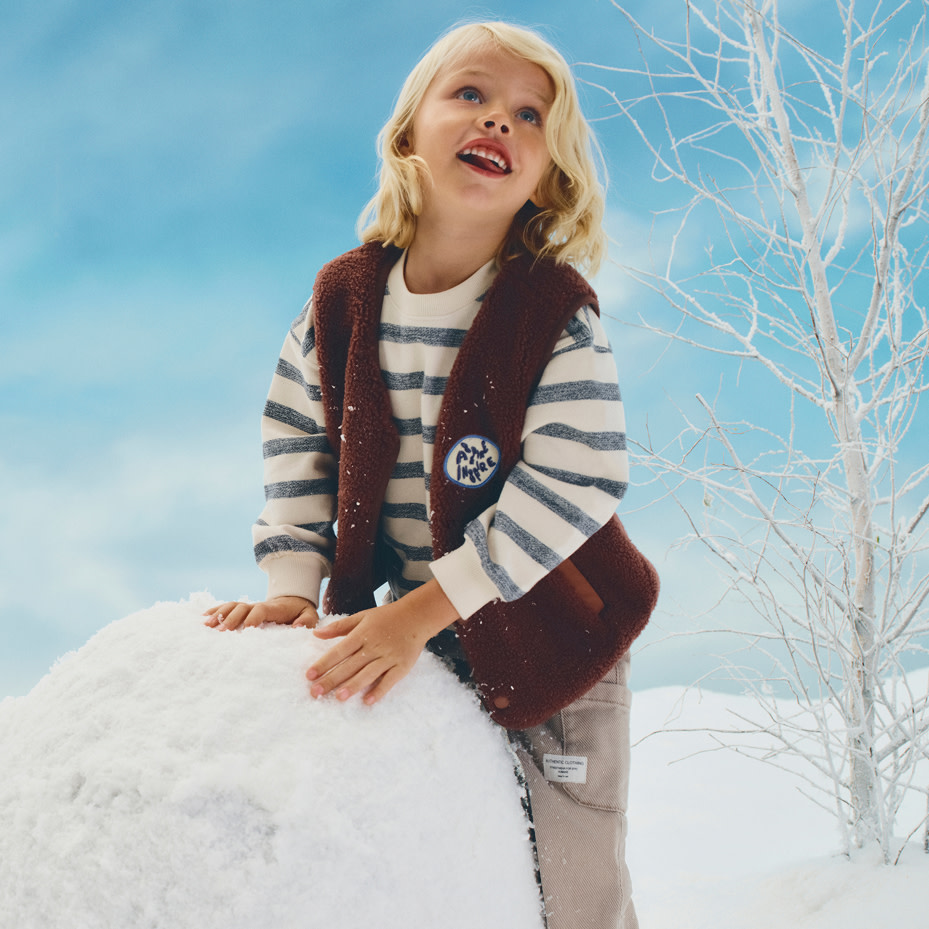 Girl wearing striped top and brown gilet
