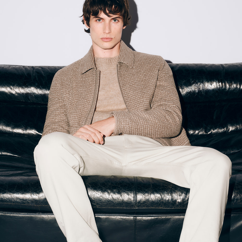 Men wearing ecru trousers, beige top and jacket