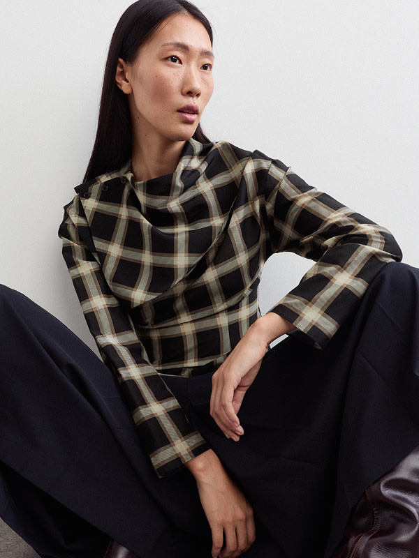 Woman wearing checked top
