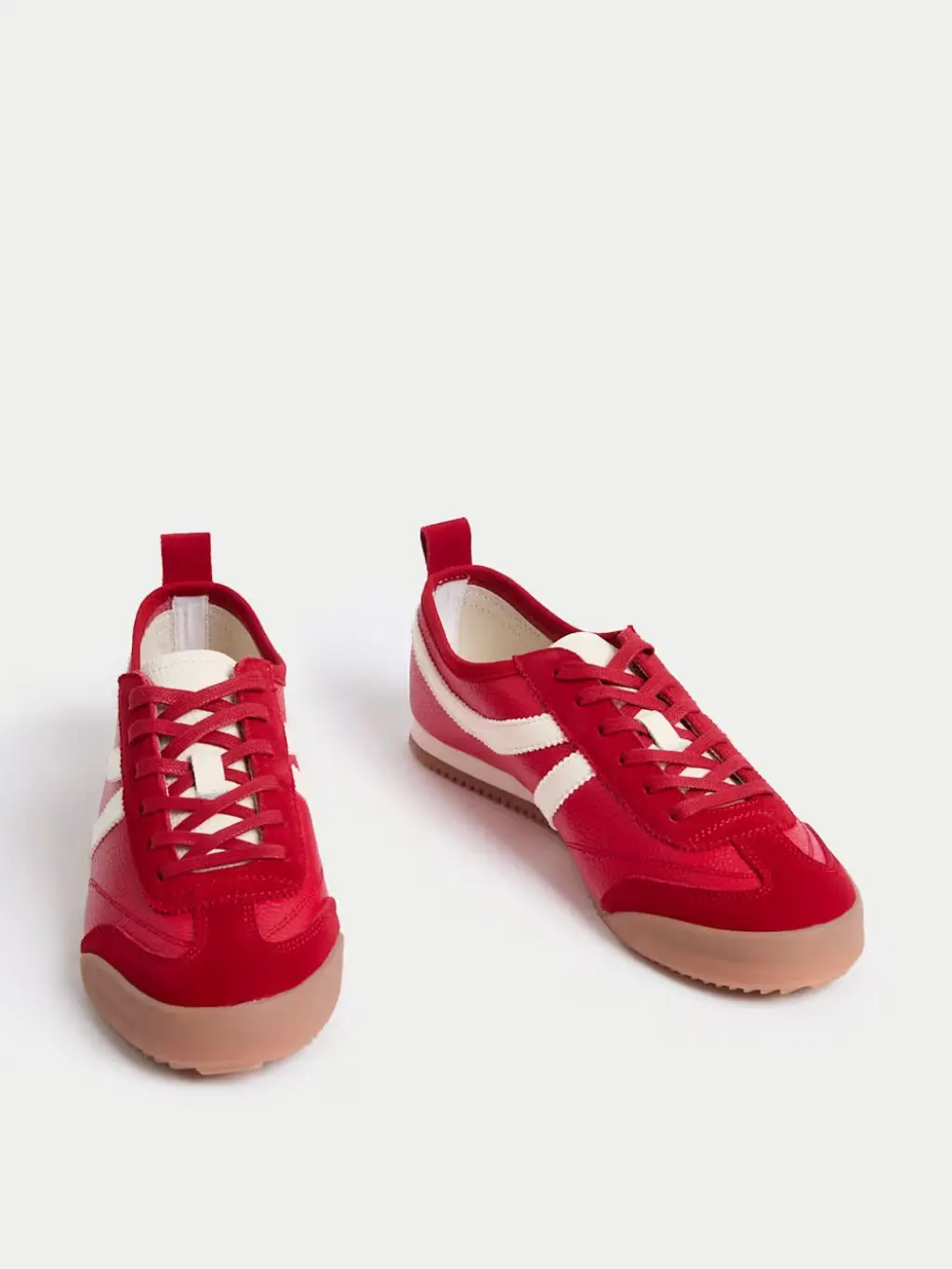 A cutout out of red and white trainers