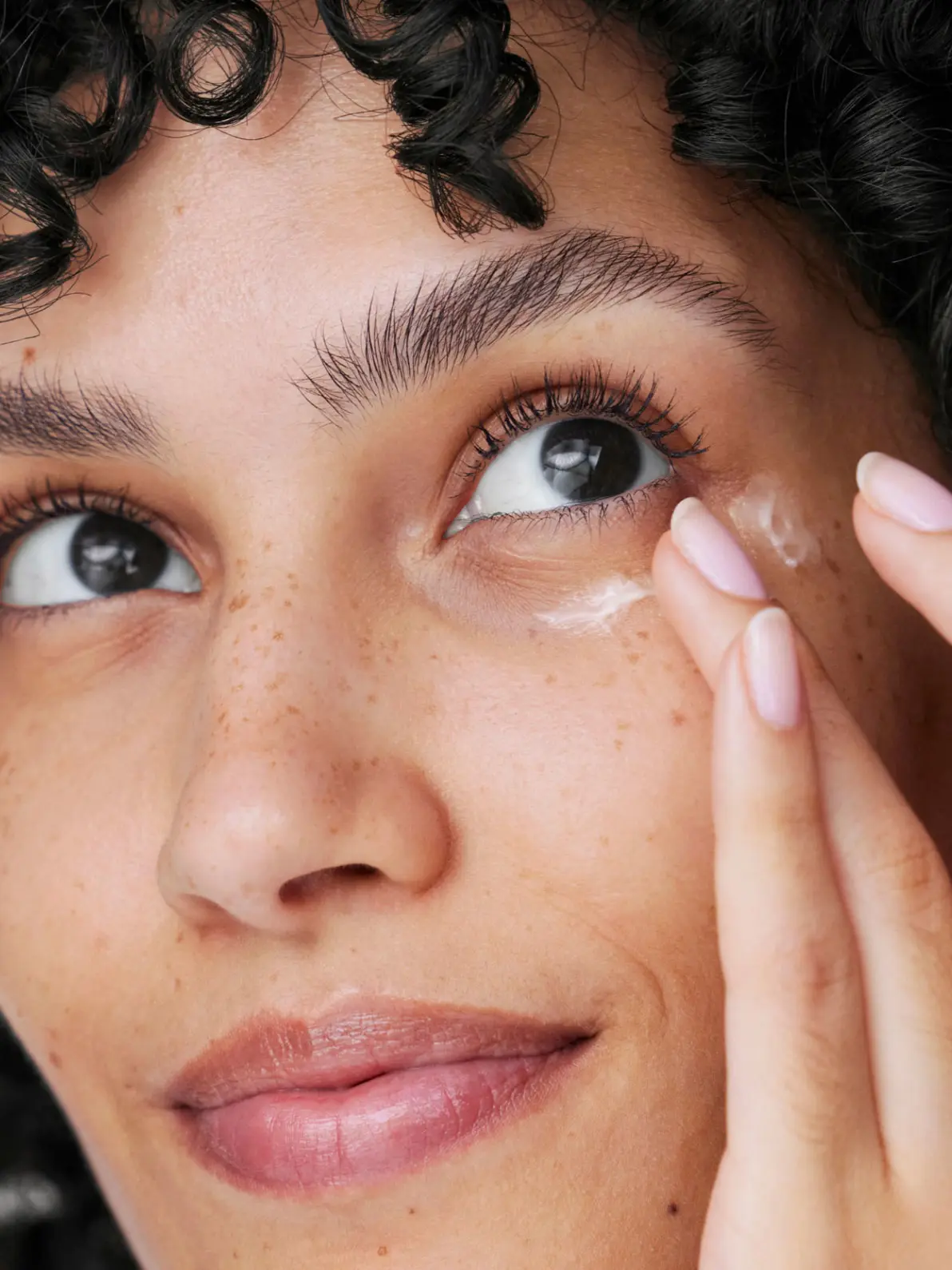 Woman applying eye cream