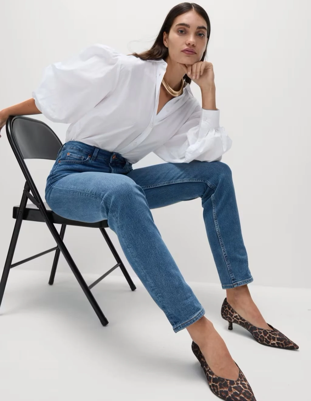Woman wearing straight-leg jeans and white shirt at M&S