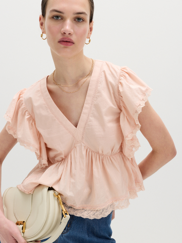 Woman wearing pink lace top