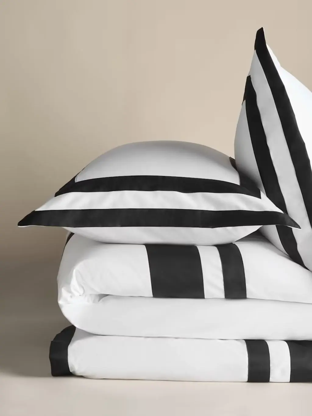 A close up up of bed linen with a black border by Kelly Hoppen x M&S