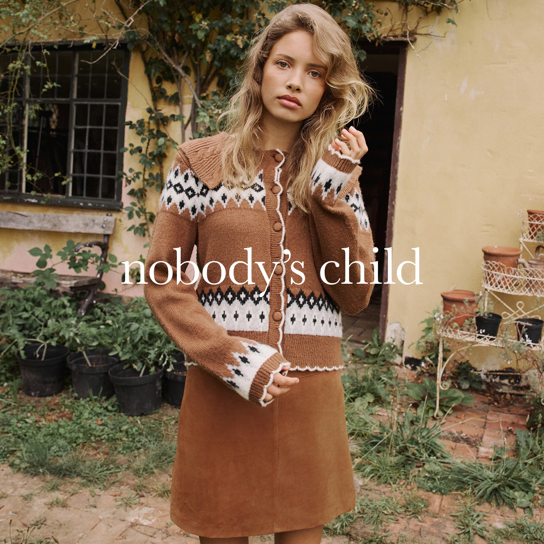 Woman wearing camel Fair Isle cardigan and skirt by Nobody's Child