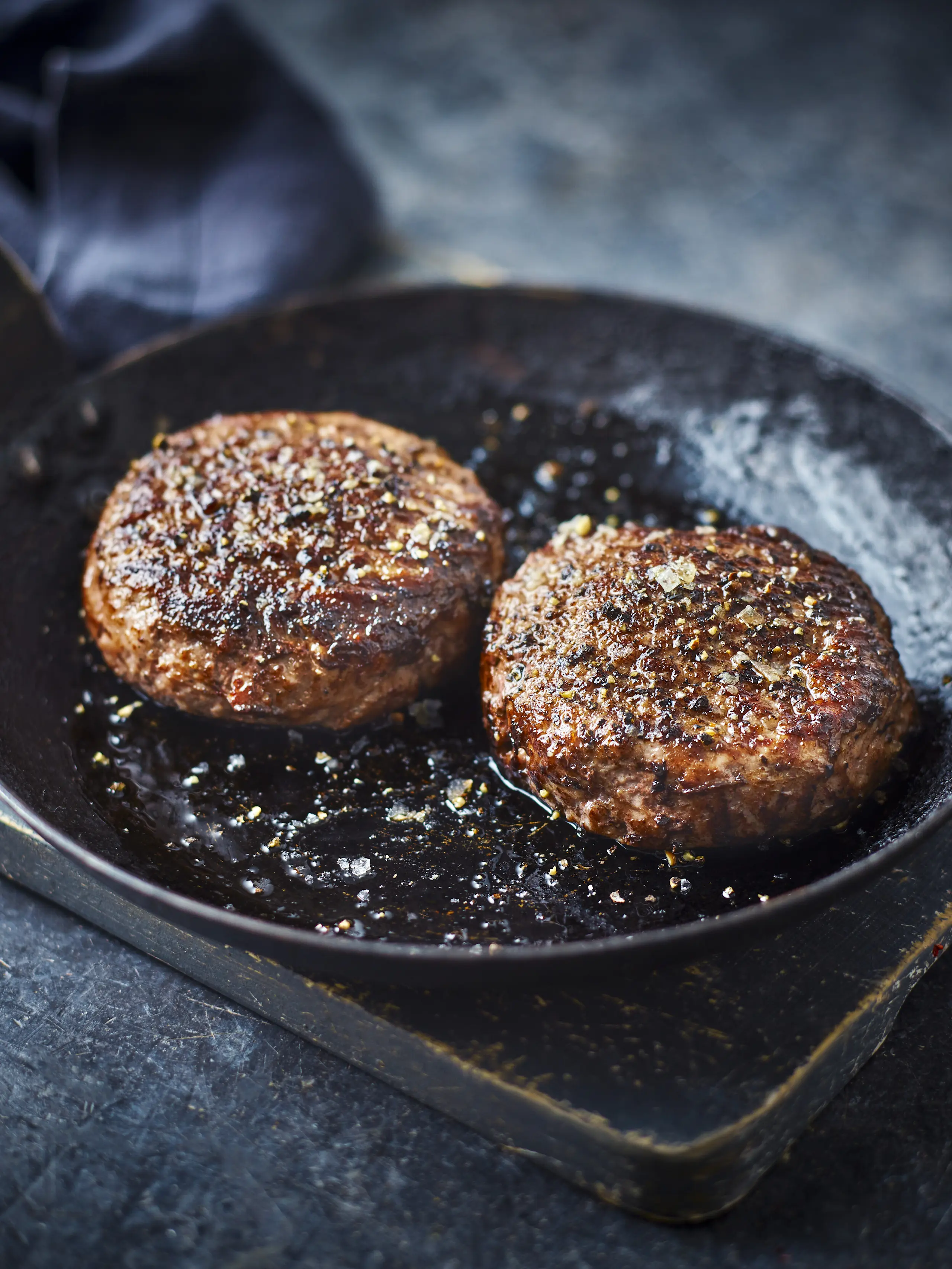 Burger patties in frying pan