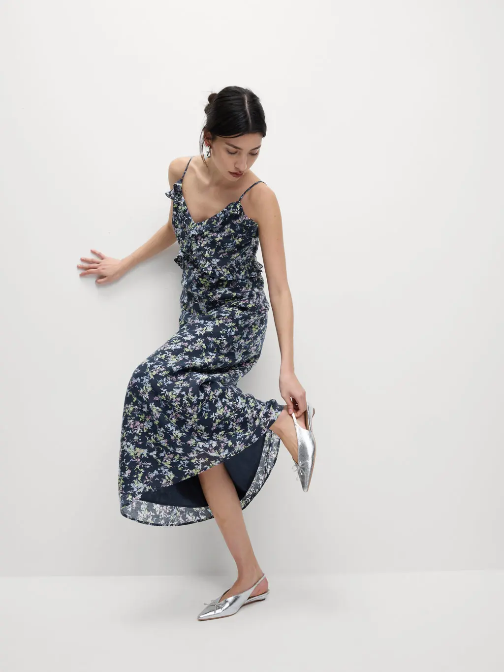 A woman wears a long maxi floral dress