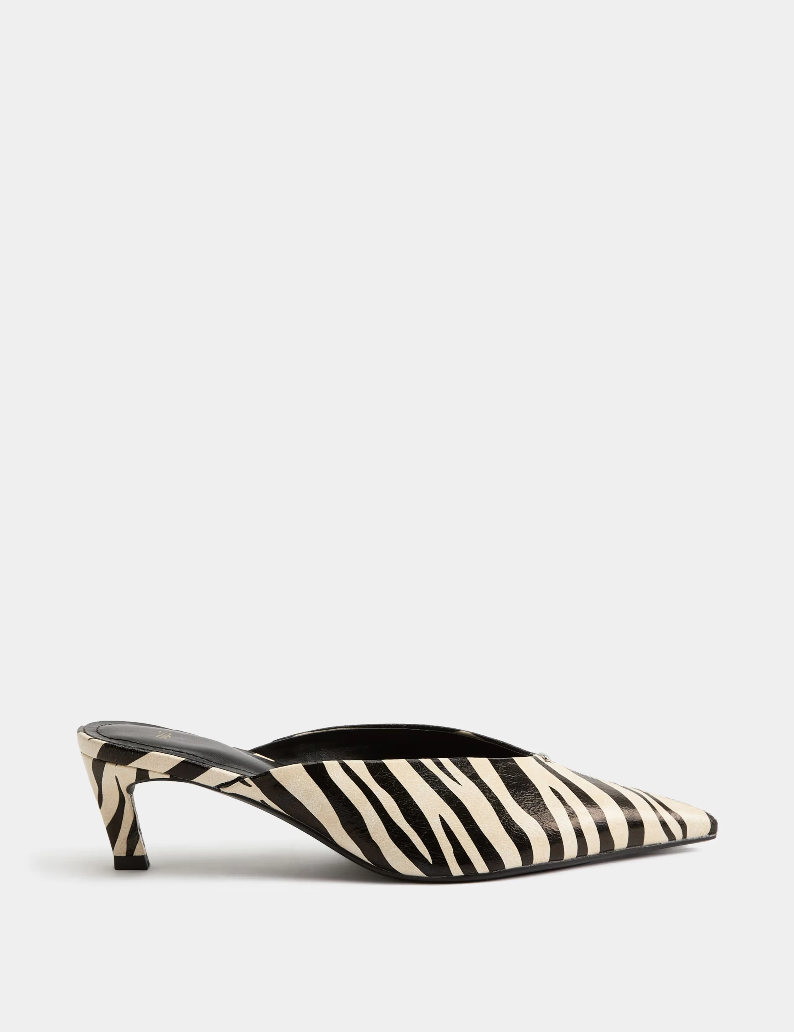 Zebra print kitten heels with a pointed toe and open back.