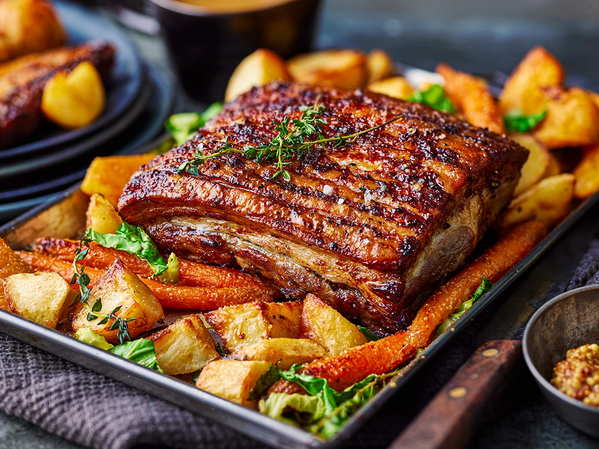 A roast dinner with crispy pork crackling and potatoes