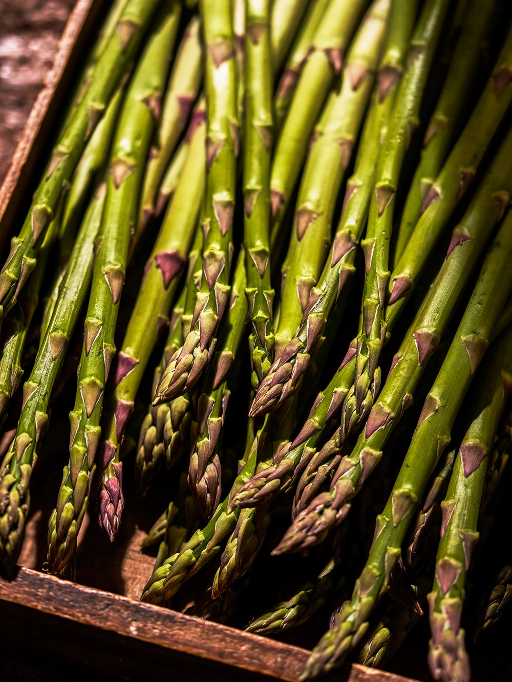 Close-up of asparagus in wooden crate