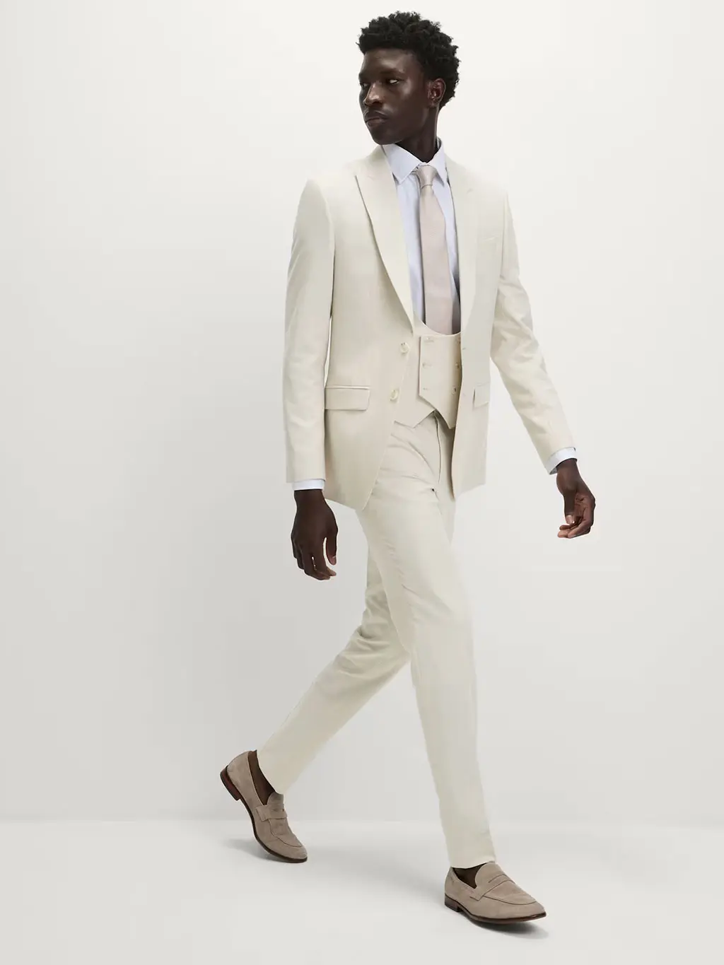 Man wearing a cream three-piece suit