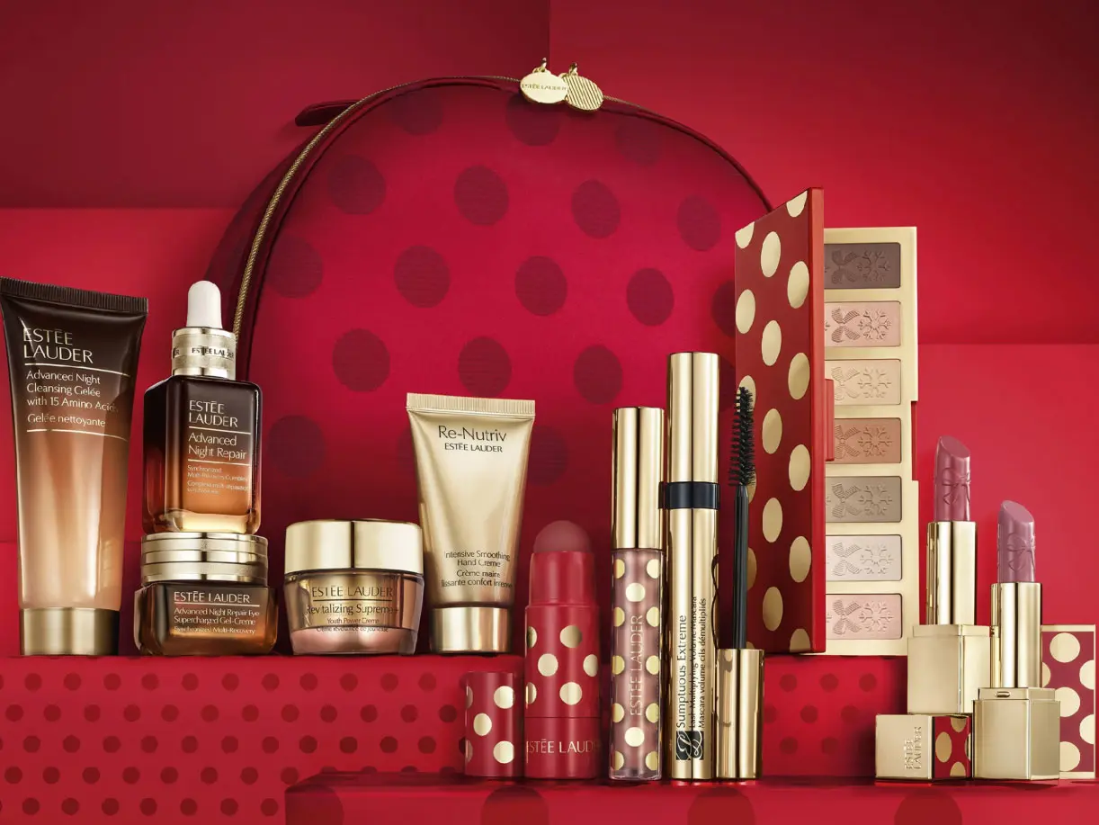 An assortment of beauty products placed in front of a red polka-dot make-up bag  