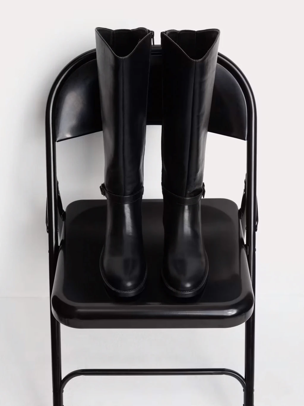 Black leather knee-high riding boots