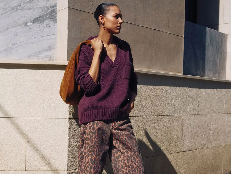 Woman wearing burgundy jumper and leopard-print jeans from Hush at M&S