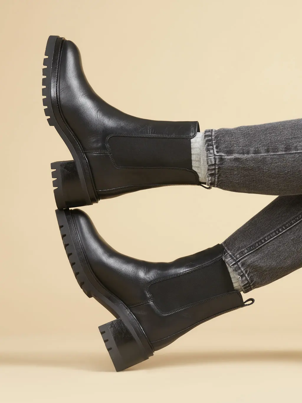 Woman wearing black ankle boots and black skinny jeans