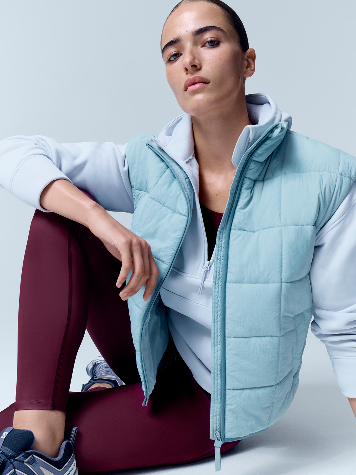 Light blue quilted gilet and burgundy leggings
