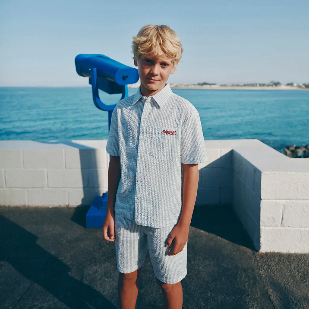 Boy wearing matching blue shirt and shorts
