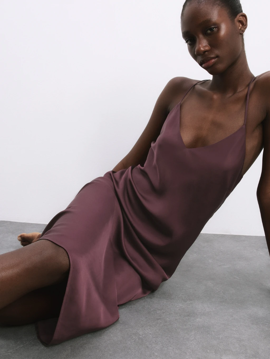 Woman wearing plum satin chemise