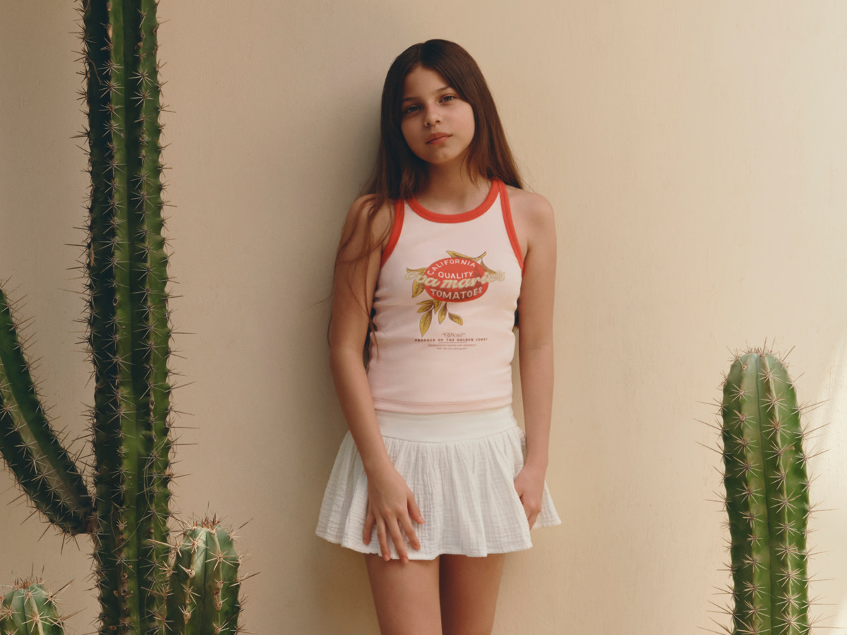 Girl in pink tank top and white skirt