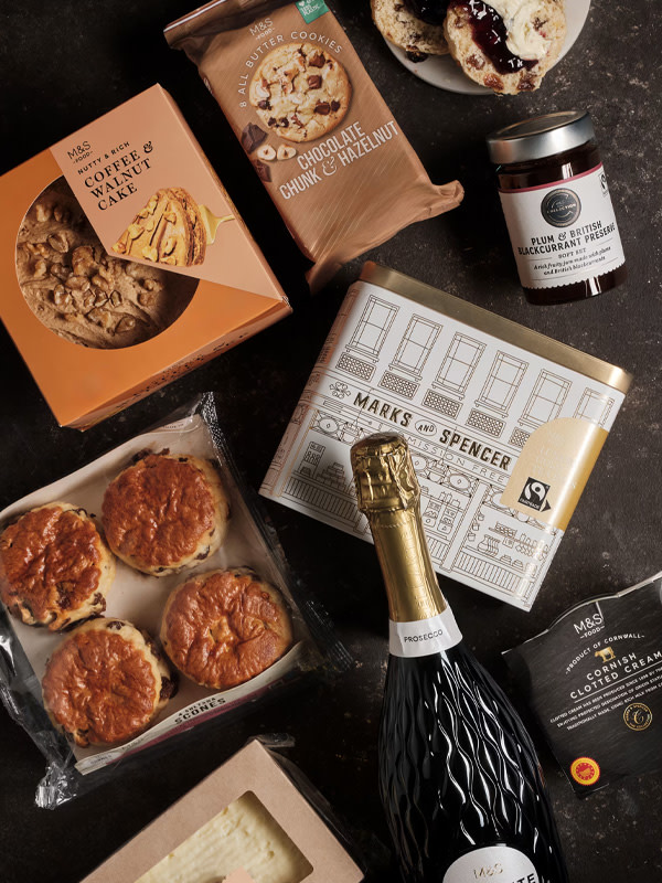Bottle of sparkling wine, scones, cakes