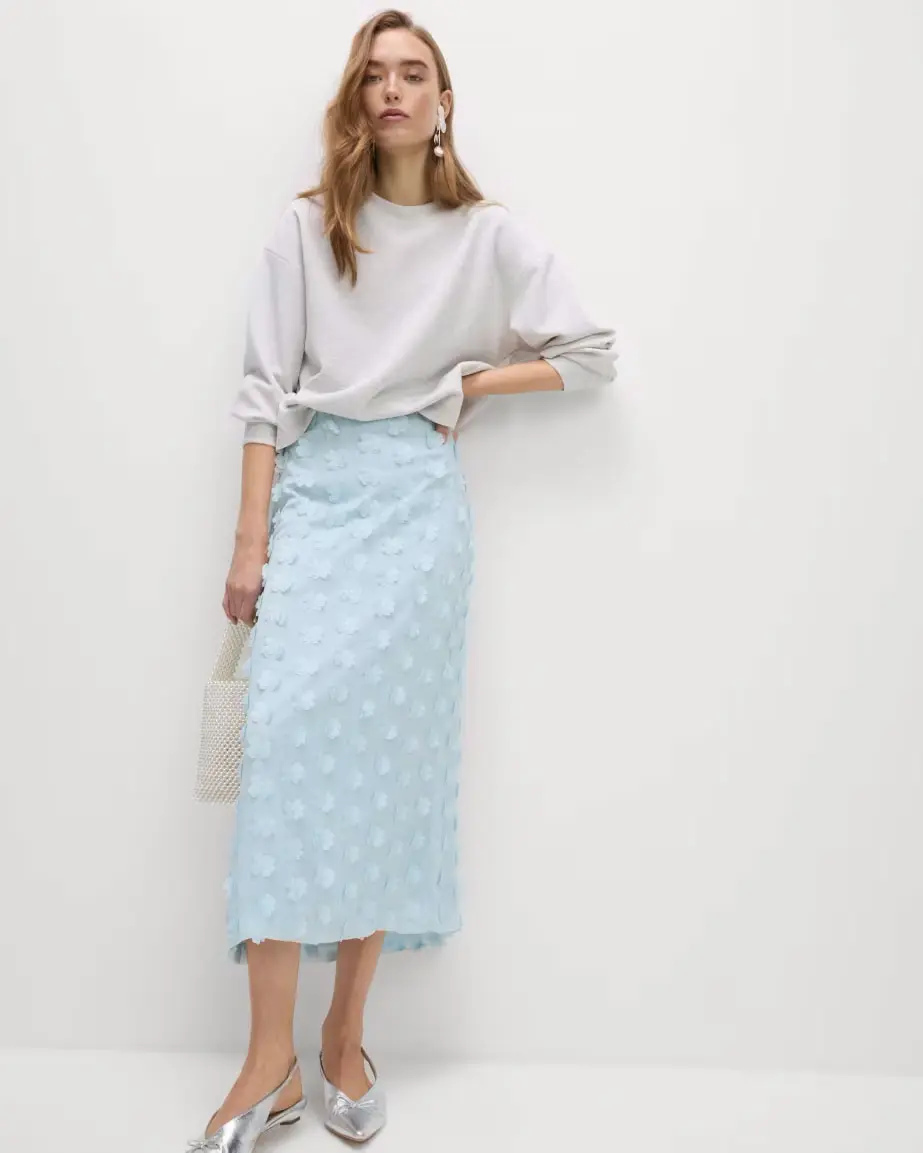 Woman wearing pale blue embellished skirt