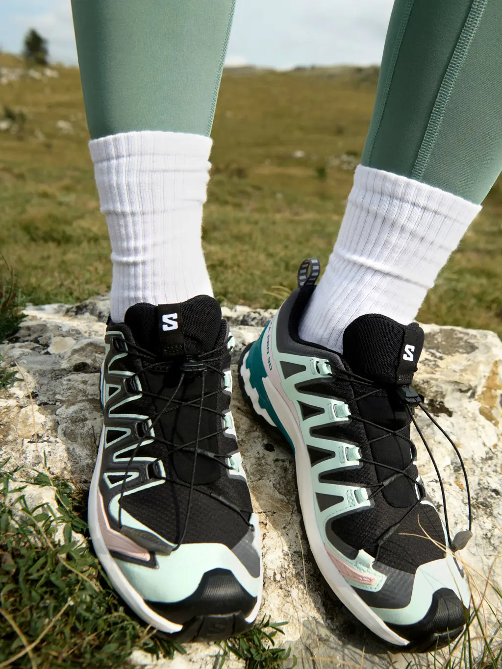 Woman wearing a pair of Salomon trail running shoes