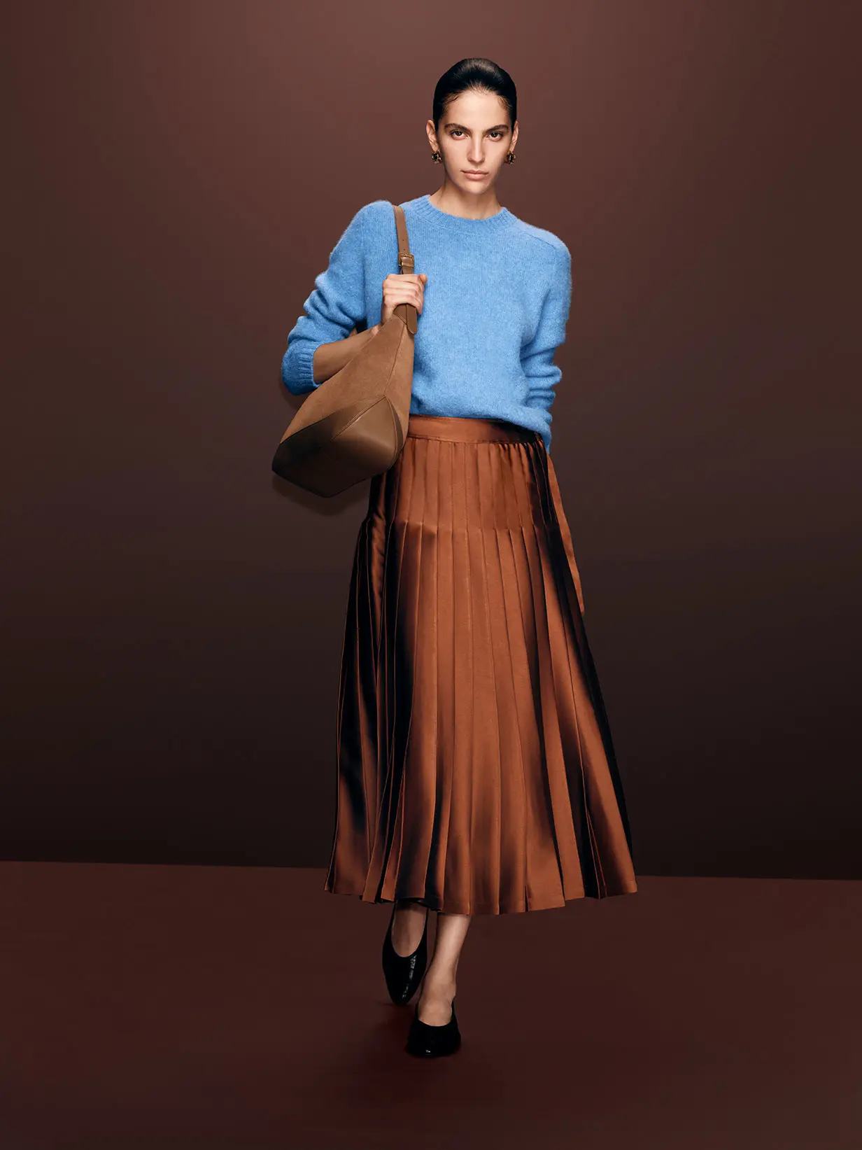 Woman wearing blue jumper and amber skirt by Autograph