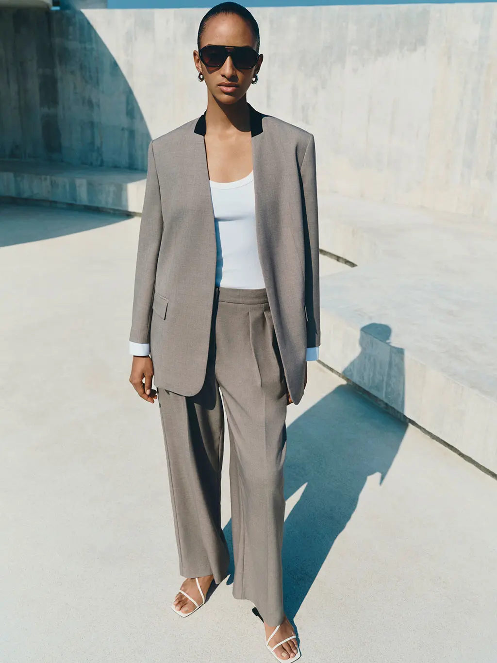 Woman wearing a two-piece suit with a white vest