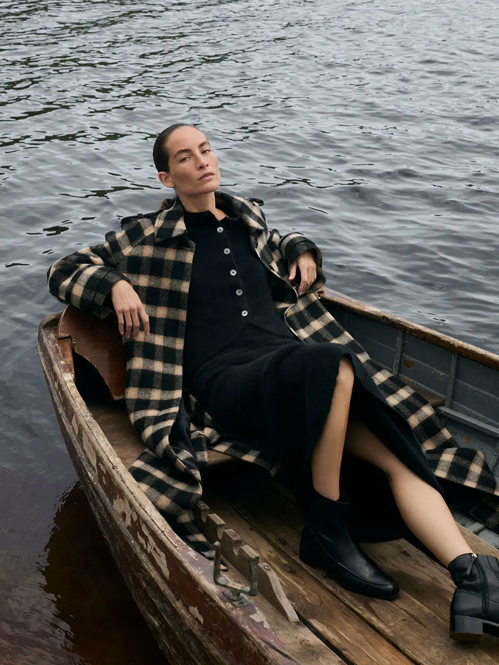 Woman in checked coat in boat