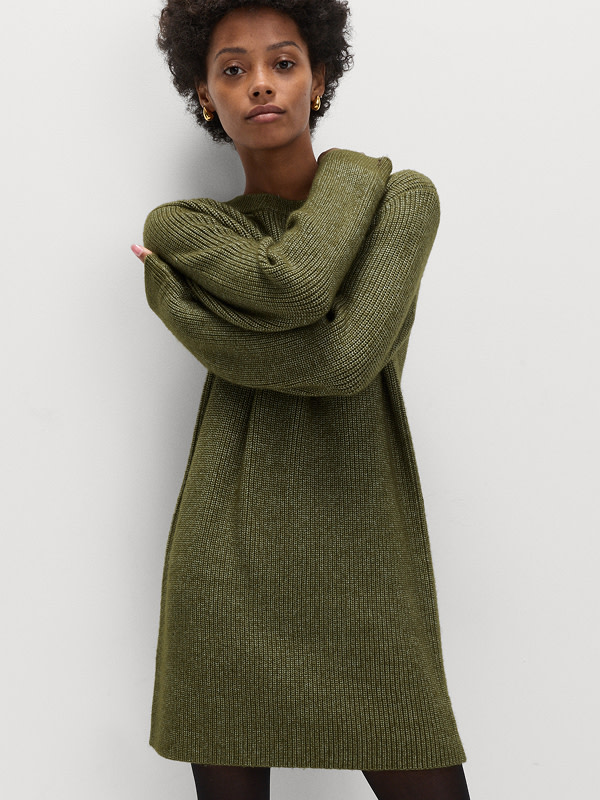 Woman wearing a khaki ribbed relaxed knitted mini dress