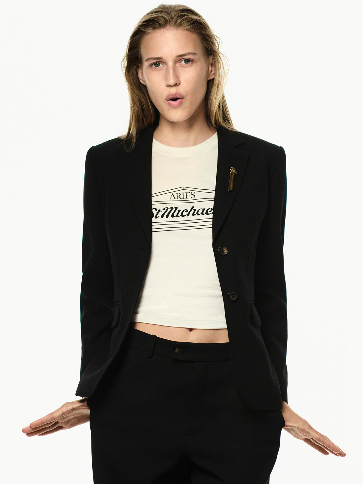 Woman wearing logo-printed T-shirt with tailored black blazer
