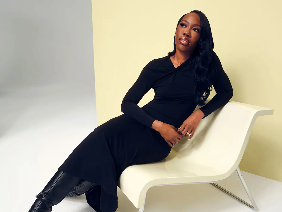 Woman wearing long black dress and black boots