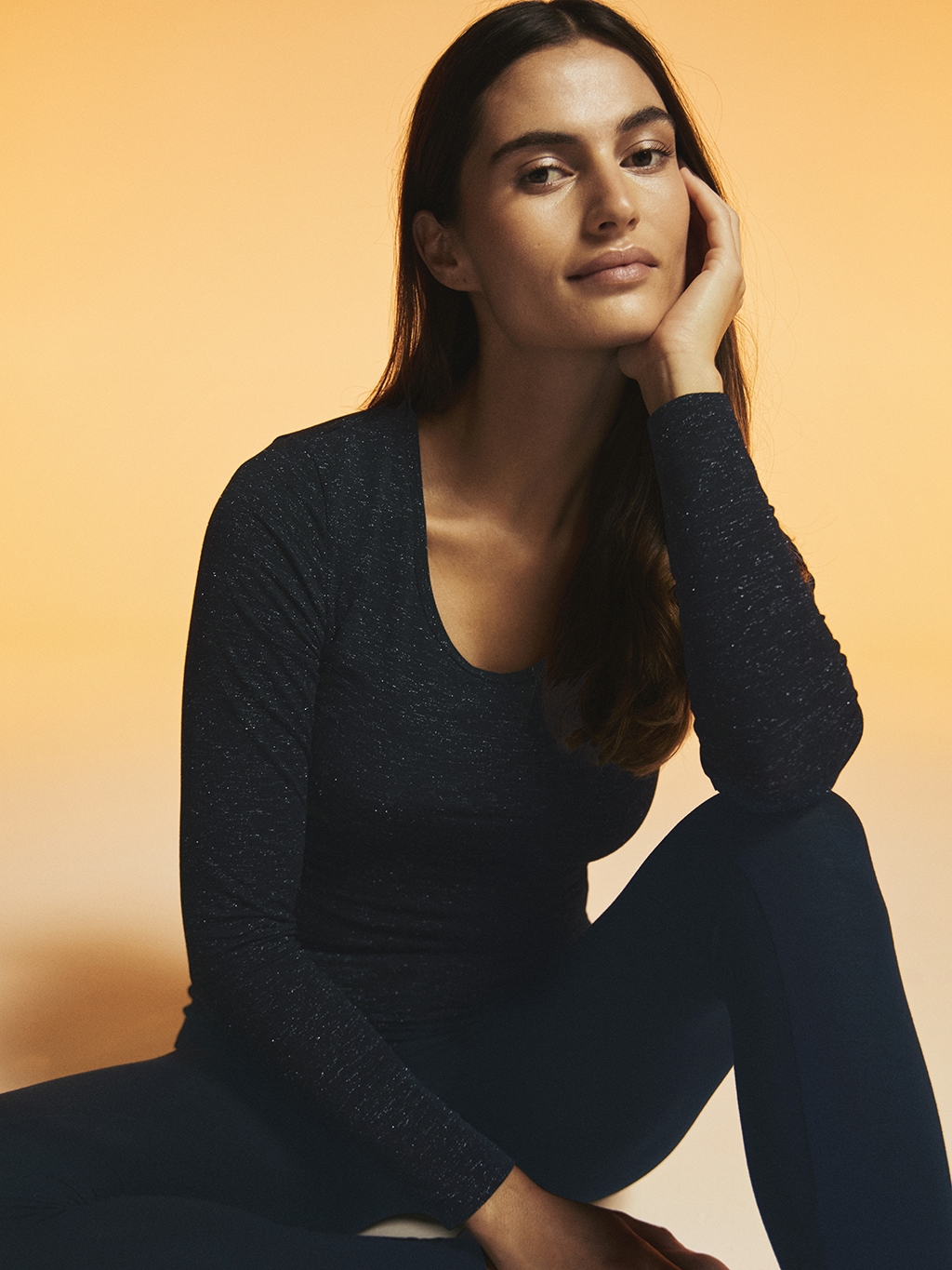 Woman wearing black thermal scoop-neck top and thermal leggings