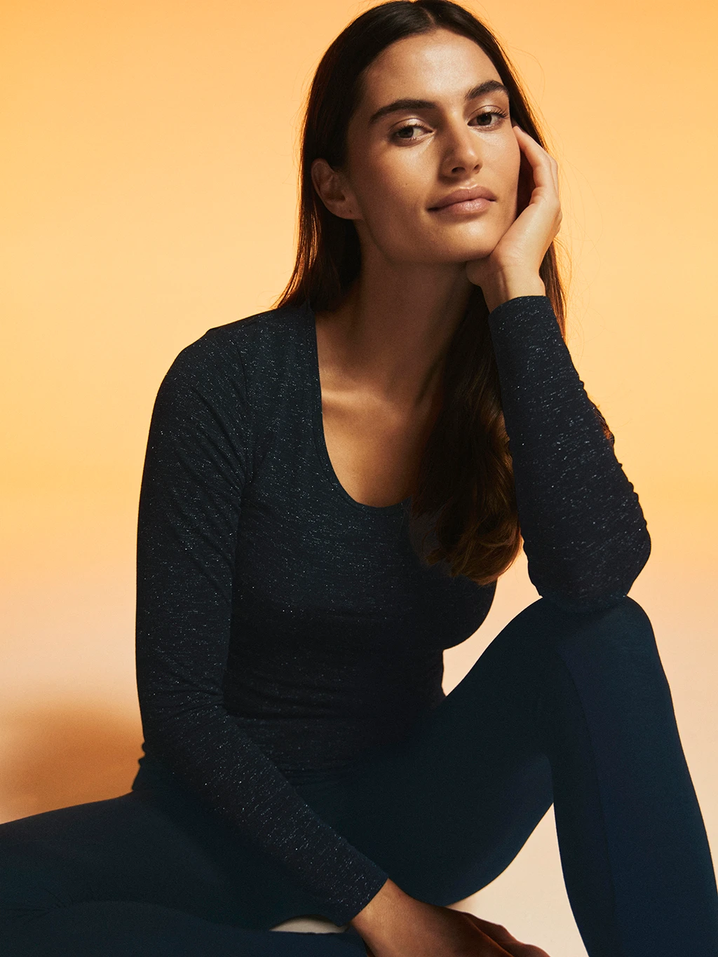 Woman wearing black thermal scoop-neck top and thermal leggings