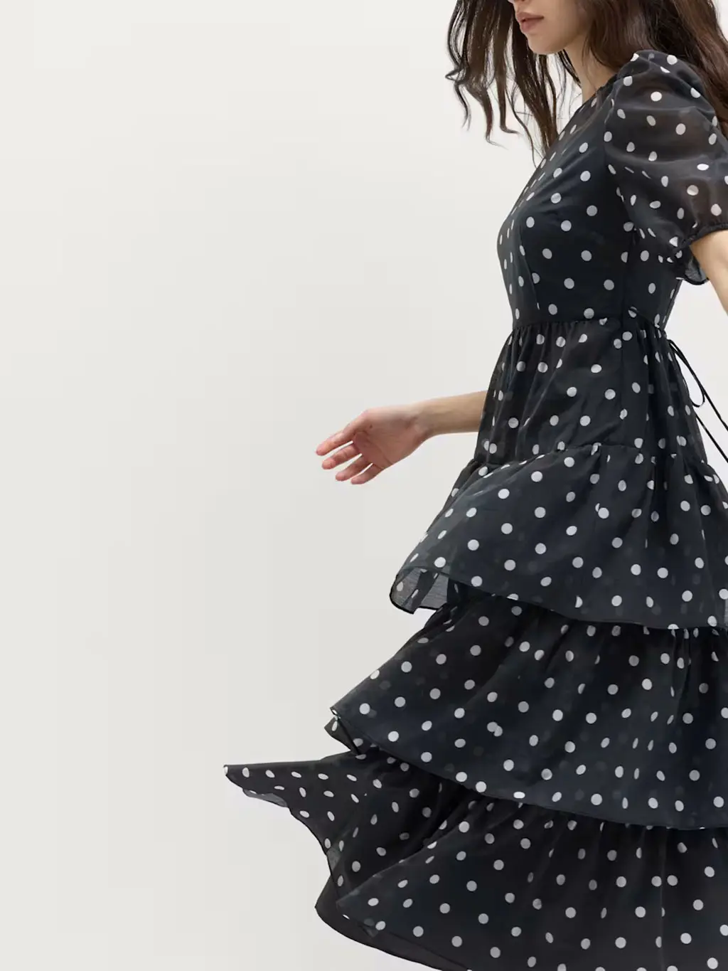 Woman wearing a black and white polka-dot dress