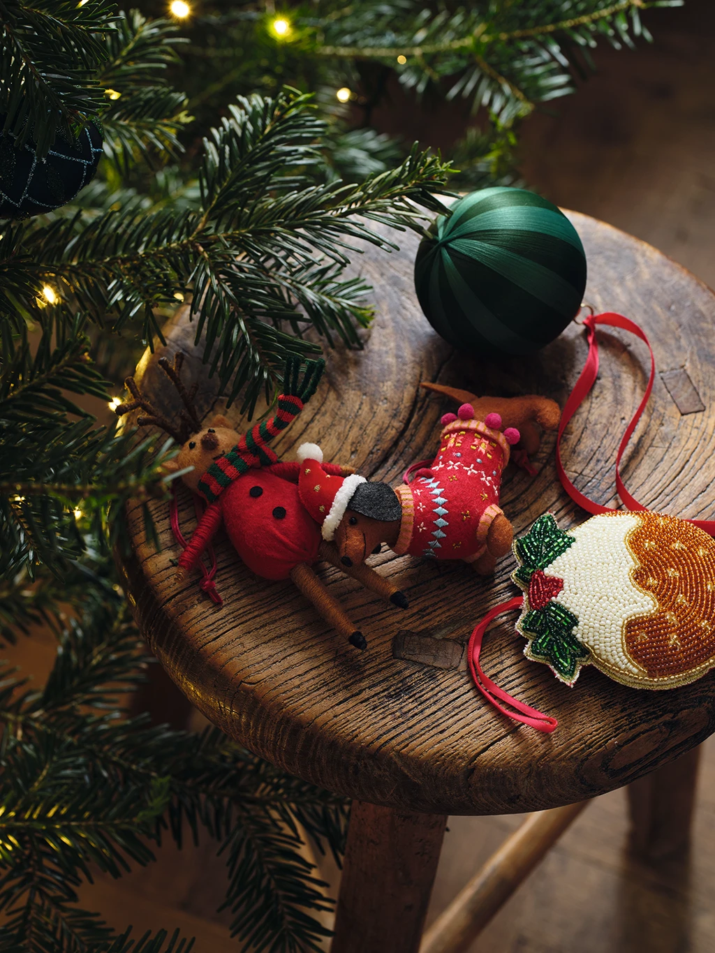 Assorted Christmas baubles and decorations on a wooden stool