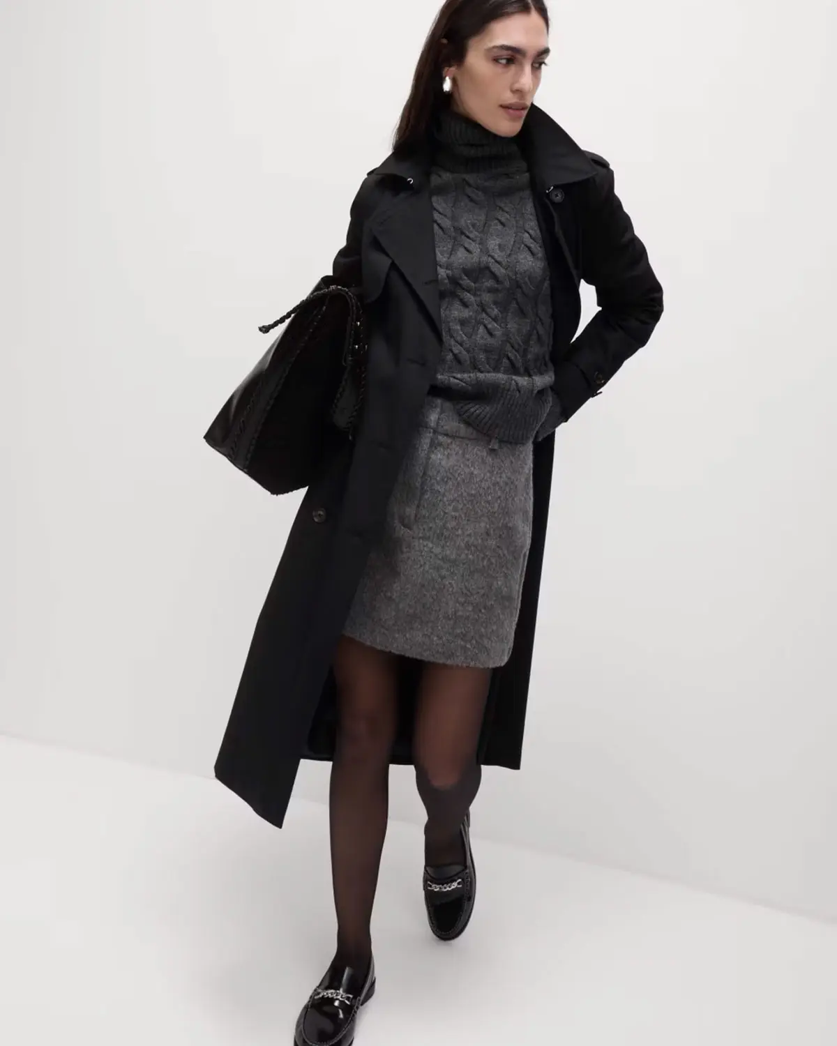 Woman wearing a black trench coat at M&S