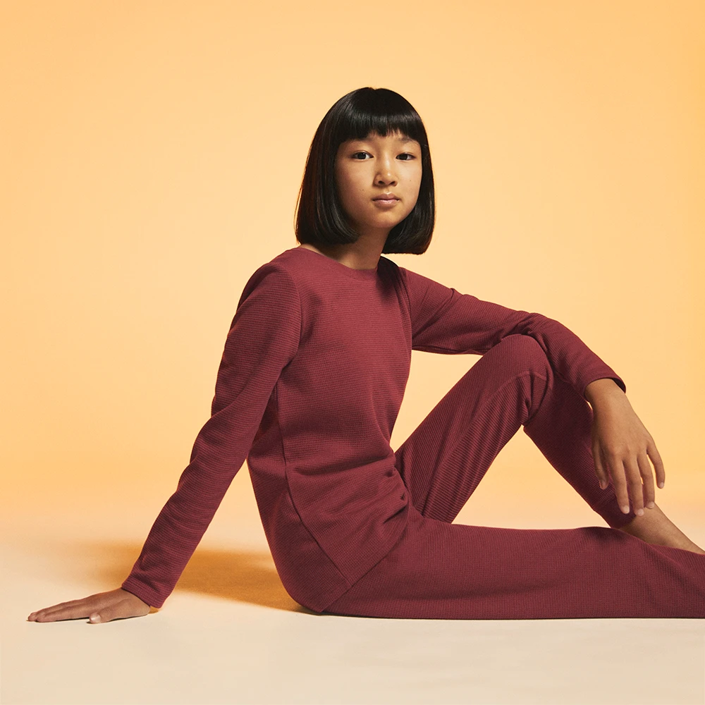 Girl wearing burgundy thermal top and bottoms