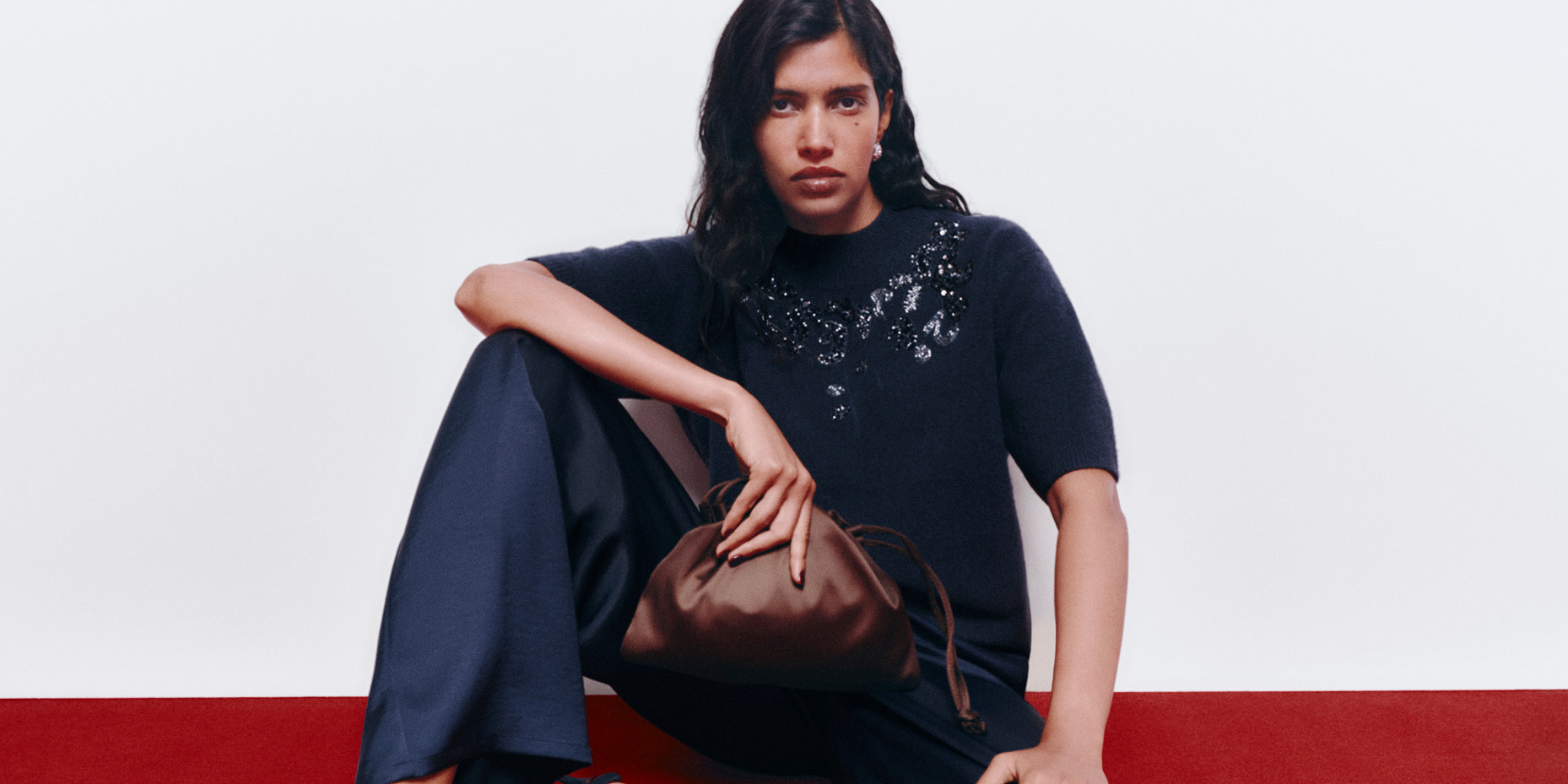Woman in black jumper with gems