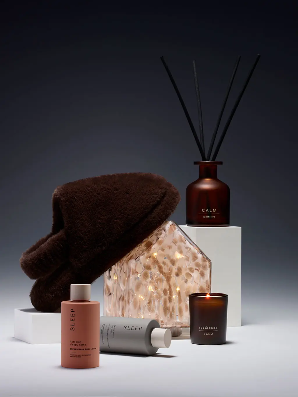 Women's stocking fillers, including slippers, a candle and a room diffuser