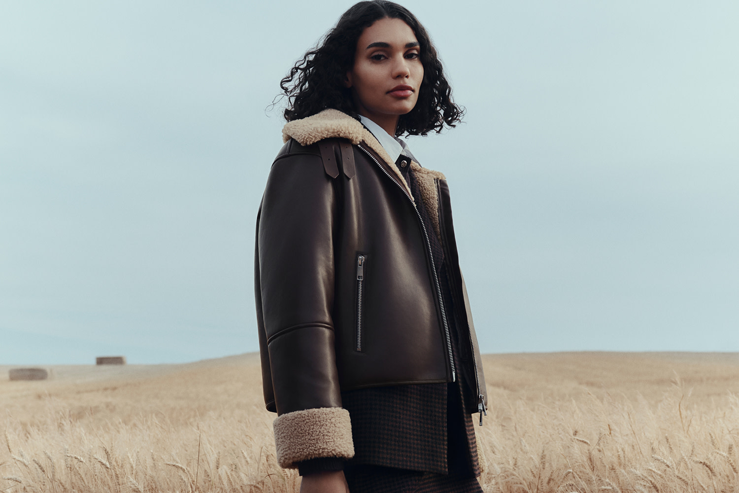 Woman wearing brown leather aviator jacket