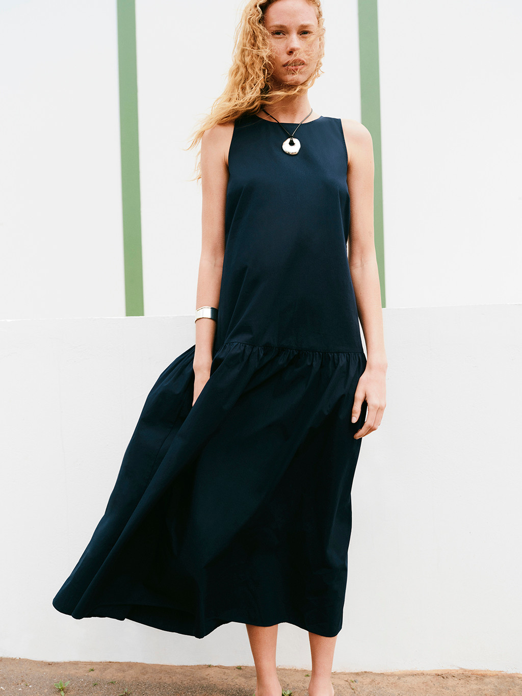 Woman wearing navy sleeveless maxi dress